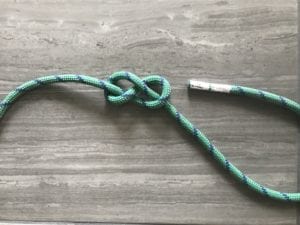 well-dressed figure eight knot pushing standing end aside