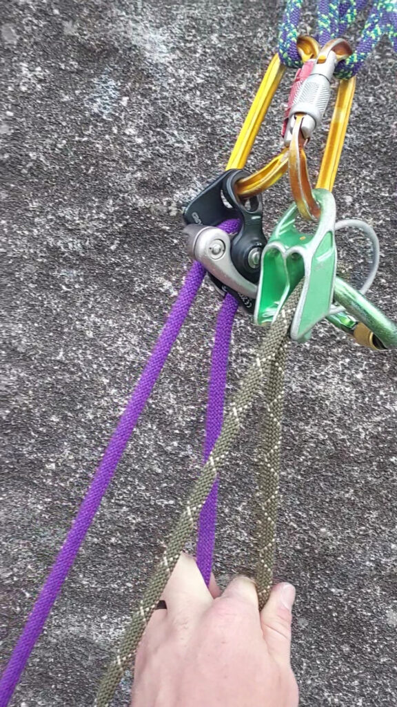climbing anchor showing the split rope technique for belaying two followers. 